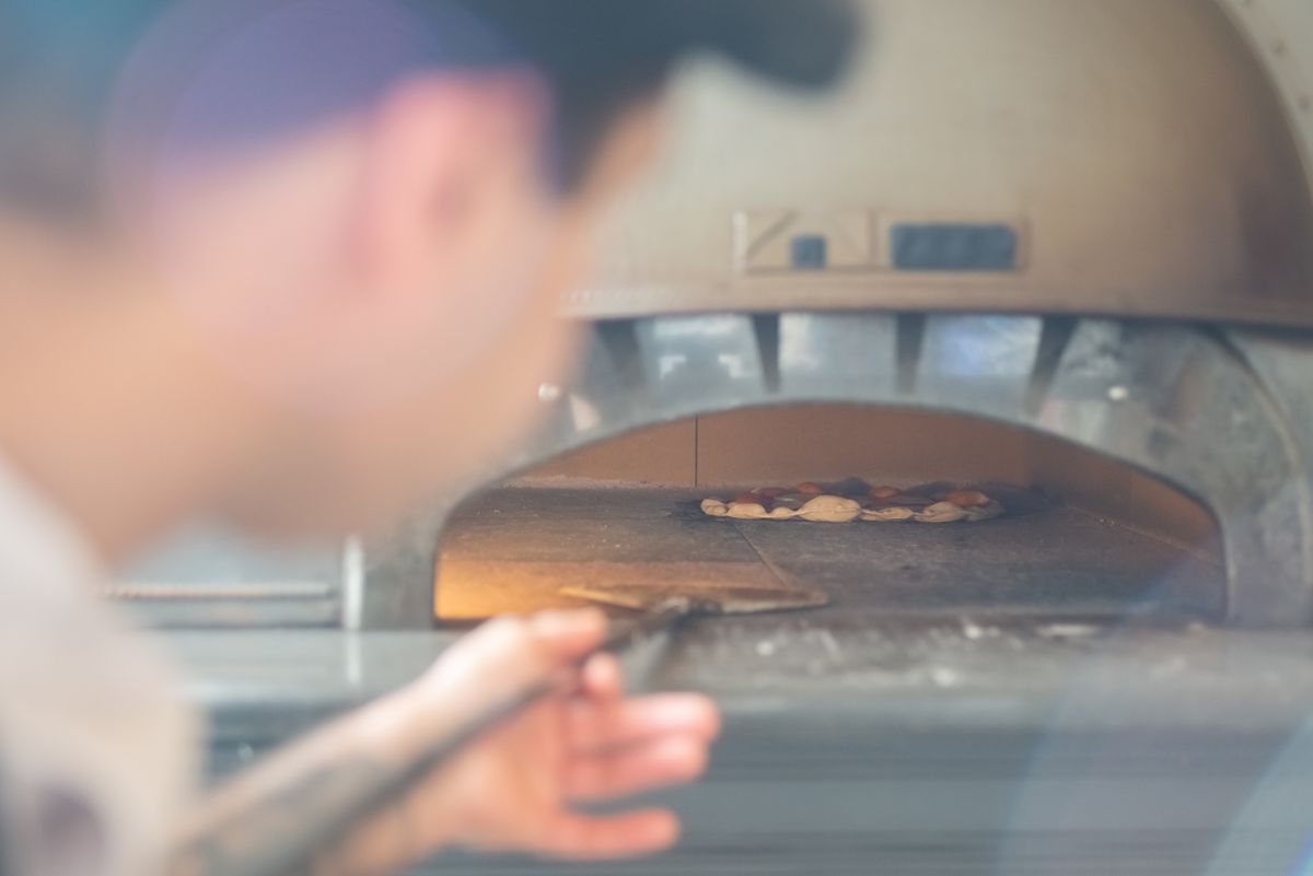 Cooking pizza in an outdoor oven
