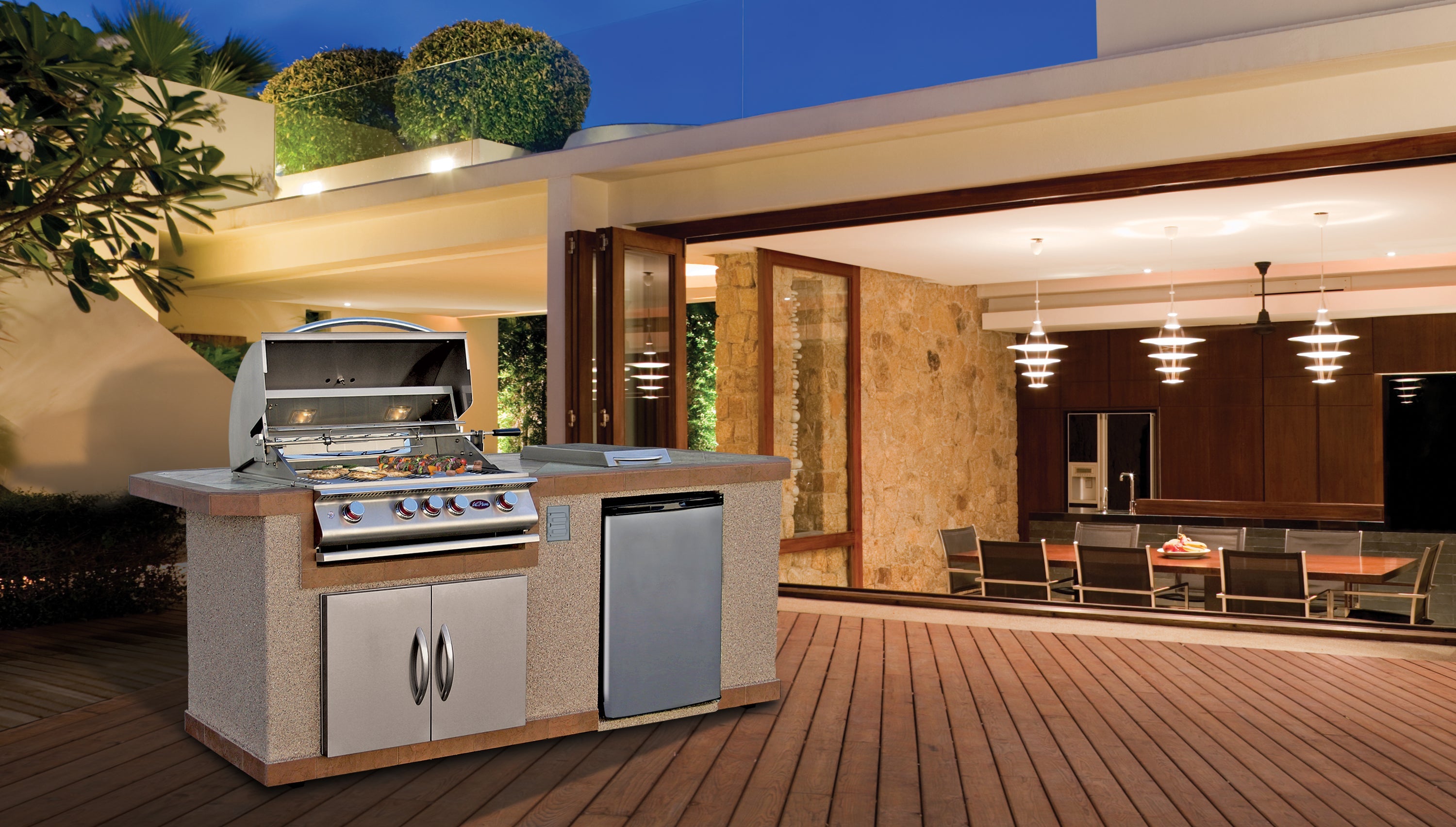 Cal Flame Bel Air Q outdoor kitchen island on a covered patio at dusk