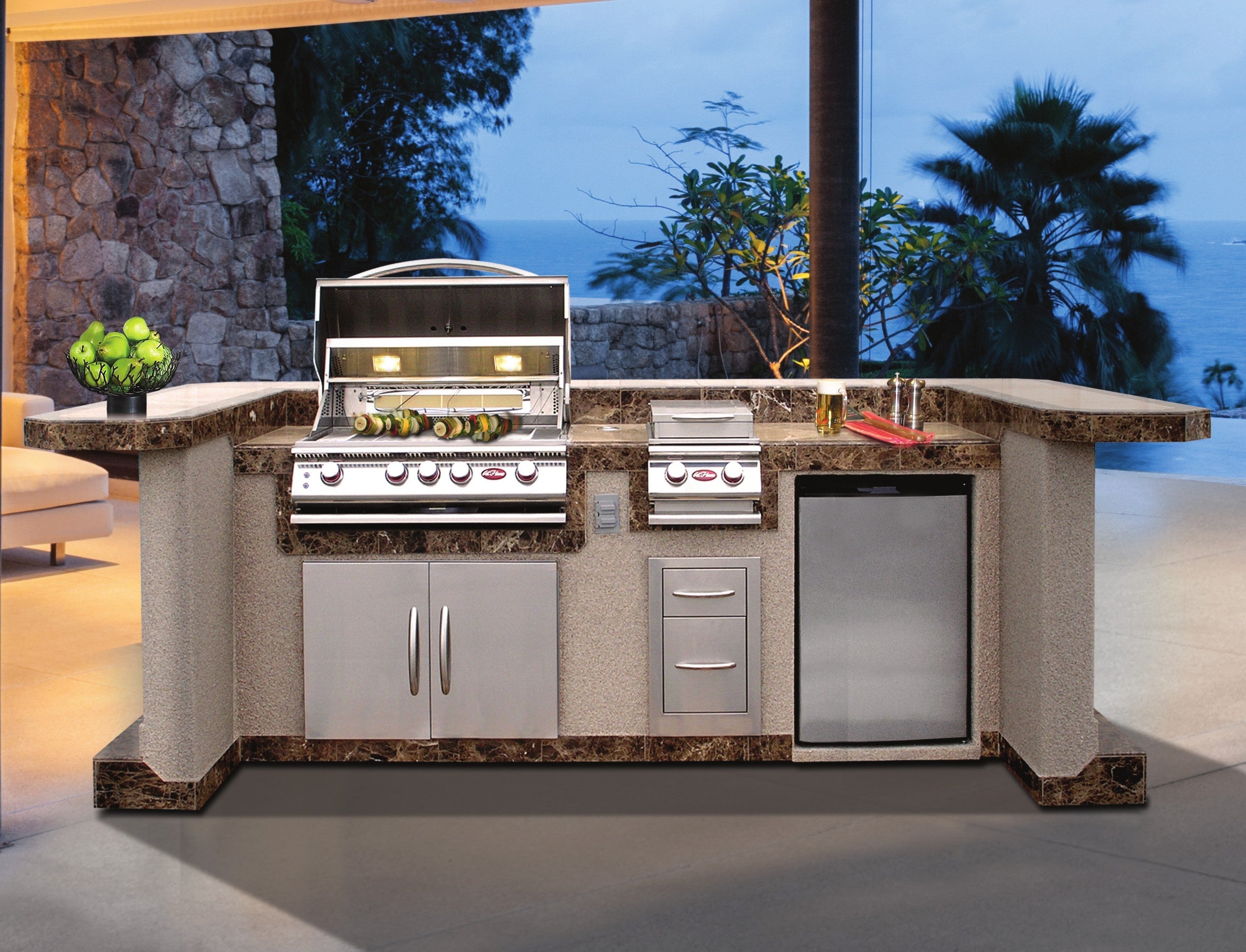 Cal Flame La Jolla Q outdoor kitchen island at twilight with palms
